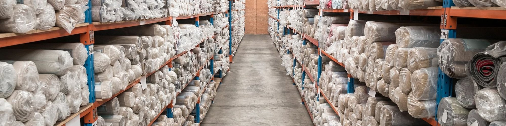 warehouse shelves with carpet rolls - Castillo's Carpet Shack in Riverside, CA