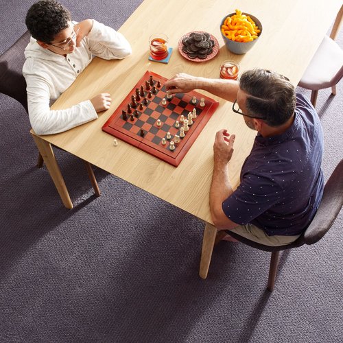 two people playing chess at the dining table - Castillo's Carpet Shack in Riverside, CA