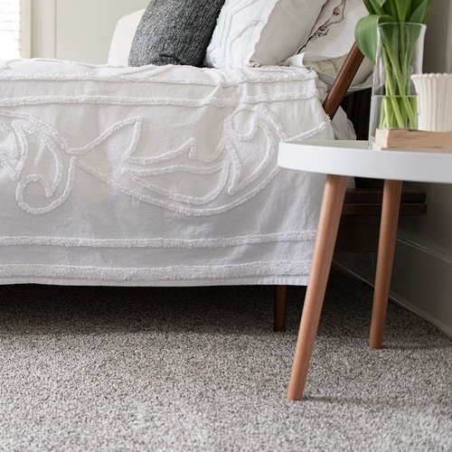 bed on carpet with small table - Castillo's Carpet Shack in Riverside, CA